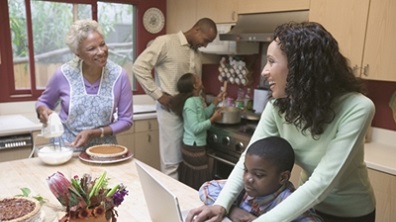 A family cooking food together in the kitchen